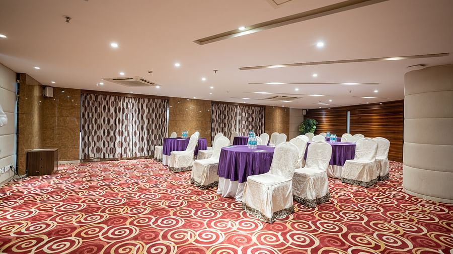 Seating arrangements inside Opal hall with light switched at The President Hotel, Hubli