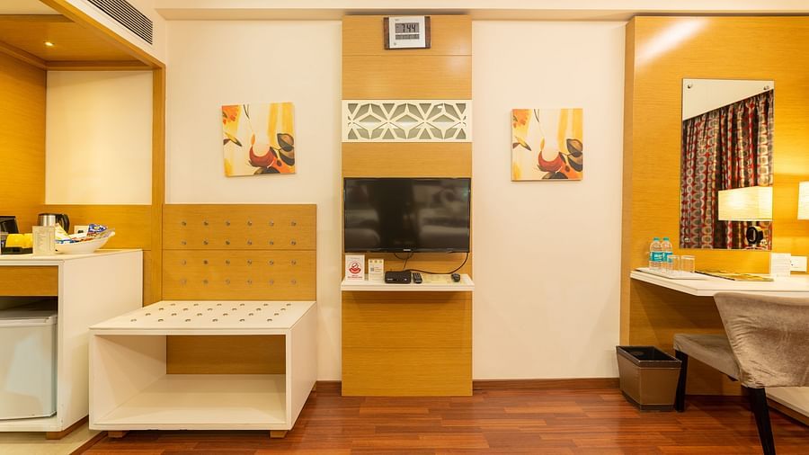 an image of room with flat screen TV at The President Hotel, Hubli
