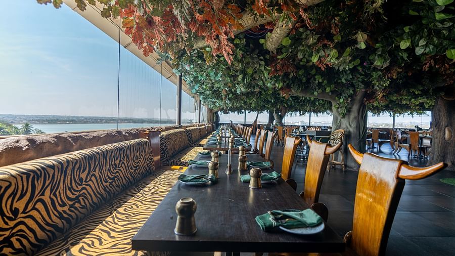 restaurant with a forest theme with an open view The President Hotel, Hubli