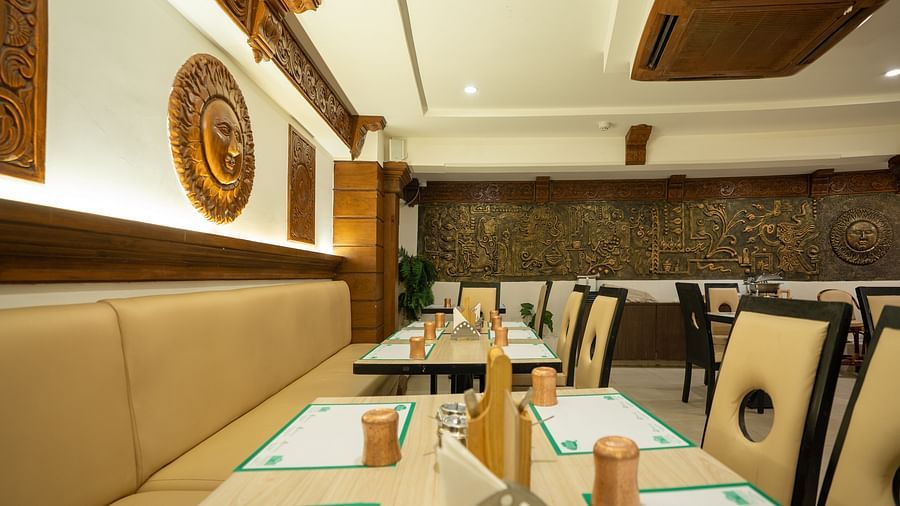 An image of a seating arrangement in a Restaurant at The President Hotel, Hubli