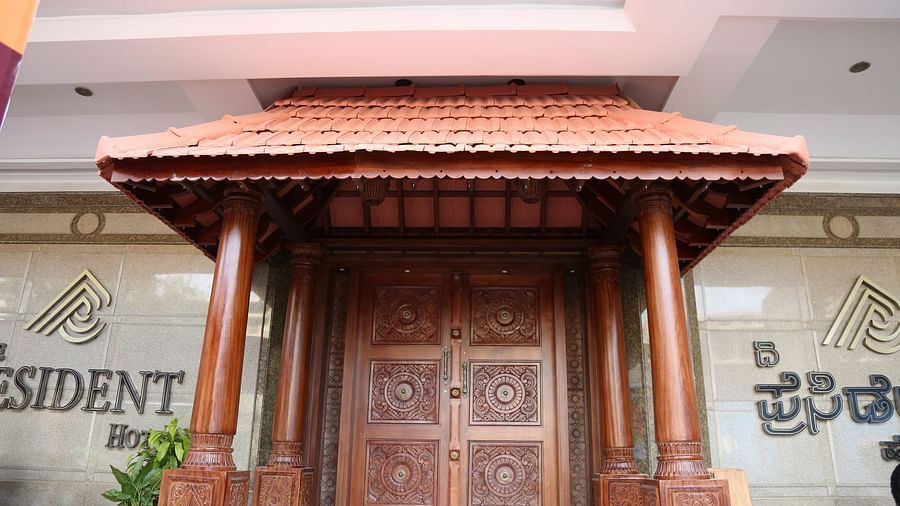 A front view of Chettinad Kitchen with wooden furnished door at The President Hotel Jayanagar, Bangalore 