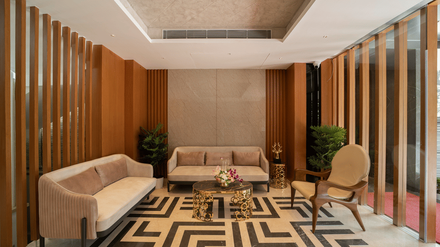 An elegant lounge at The President Hotel, Kumara Park, one of the top hotels near Palace Ground, features warm wooden panelling and modern seating.