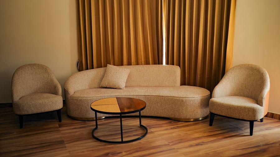 Luxury Villa with Plunge Pool featuring a lounge area with a sofa, chairs, and curtains, illuminated by warm lighting at The Qualia Resort Club & Brewery, Udaipur.