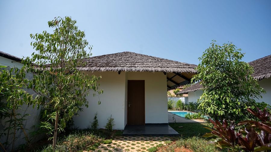 Exterior shot of the Pool View Bliss featuring a thatched roof and an entrance at The Shore, Trishvam.