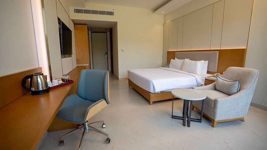 Full view shot of the Garden Courtyard featuring a double bed along with a work desk and chair at The Shore, Trishvam.