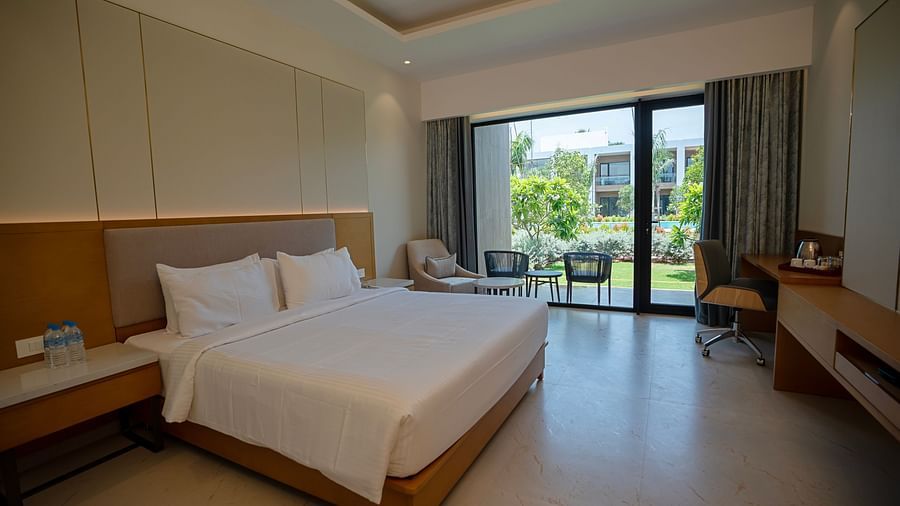 The Garden Courtyard room with huge french windows in the corner of the room at The Shore, Trishvam.