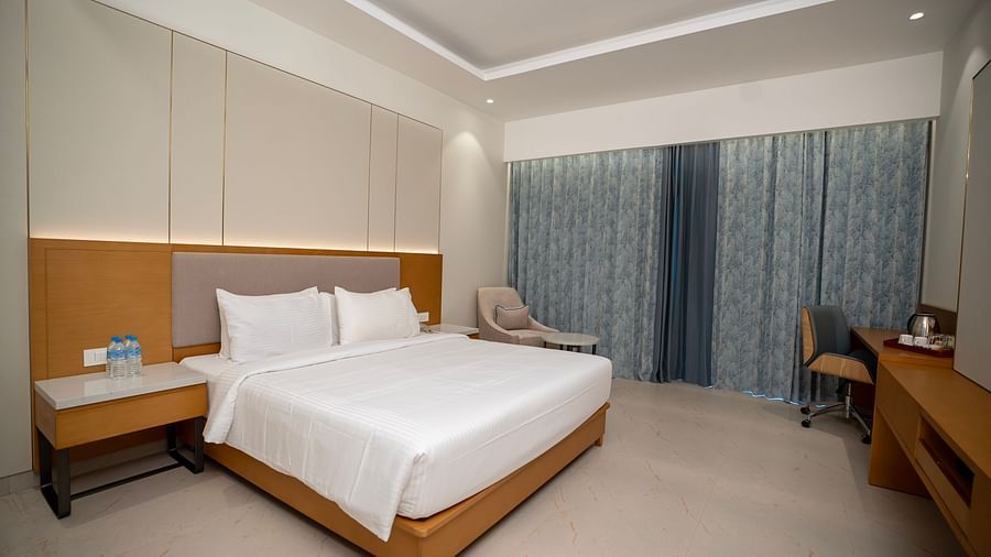 The Garden Courtyard room with pastel blue curtains covering the windows at The Shore, Trishvam.