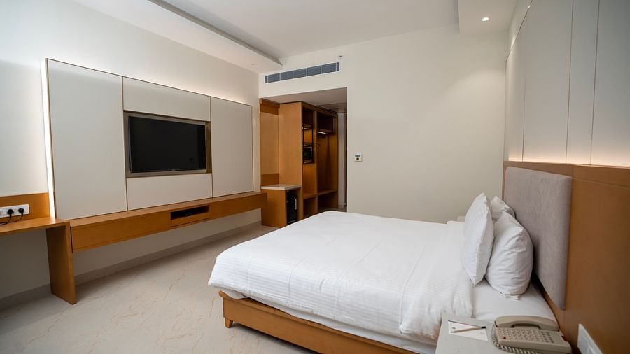 Corner view shot of the Garden Courtyard room featuring a double bed and a flat screen television at The Shore, Trishvam.