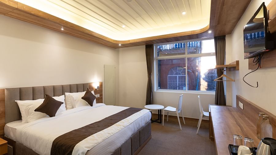 image of the standard room with a window in the corner at The Soma Hotel by Avianna Group, Darjeeling