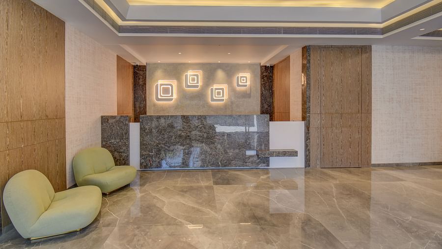 A luxurious lobby at a hotel with reception desk, ambient lighting and sofa | The SSK Solitaire Boutique Hotel & Spa, Gangapur Road - Nashik