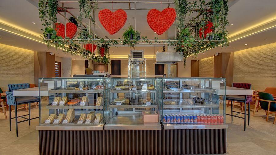 Over view of two sister's cafe The SSK Solitaire Boutique Hotel & Spa, Gangapur Road - Nashik featuring baked goods and chairs.