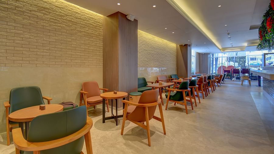 Side view of two sister's cafe The SSK Solitaire Boutique Hotel & Spa, Gangapur Road - Nashik featuring tables and chairs.
