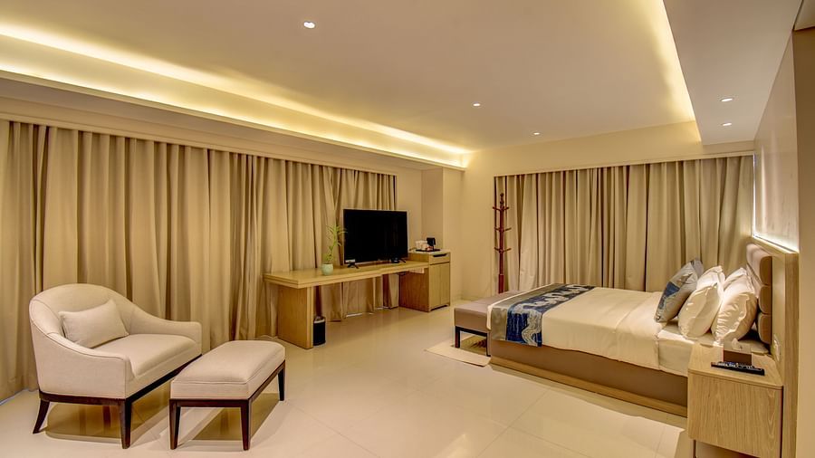 A hotel room with two beds, a television, and a desk, bright interior lighting - The SSK Solitaire Boutique Hotel & Spa, Gangapur Road - Nashik