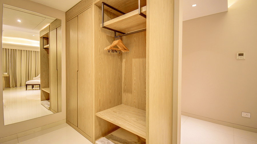 A hotel room with an open closet, a mirror, and a view of the bed - The SSK Solitaire Boutique Hotel & Spa, Gangapur Road - Nashik