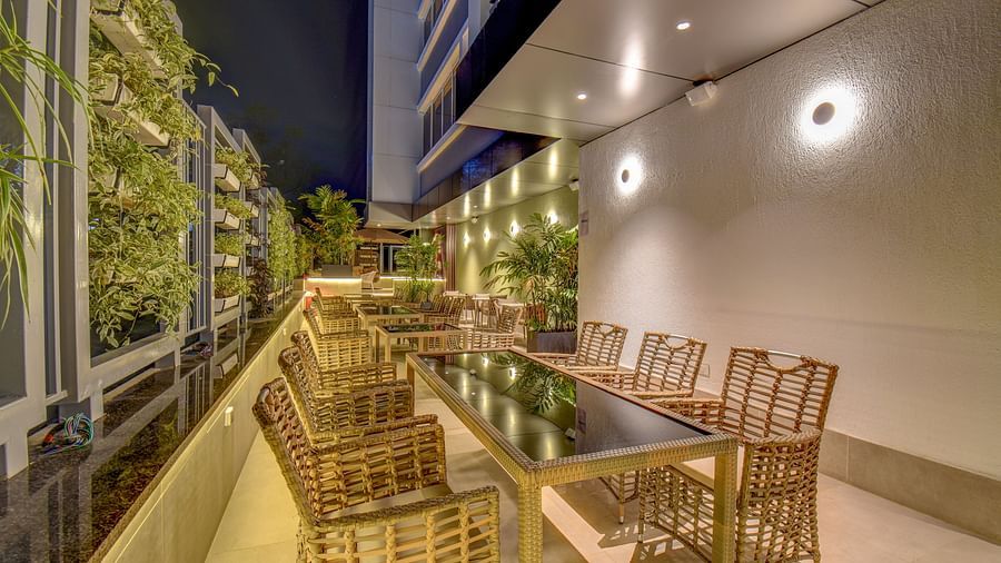Seating area of a restaurant with table and chairs on a terrace | The SSK Solitaire Boutique Hotel & Spa, Gangapur Road - Nashik
