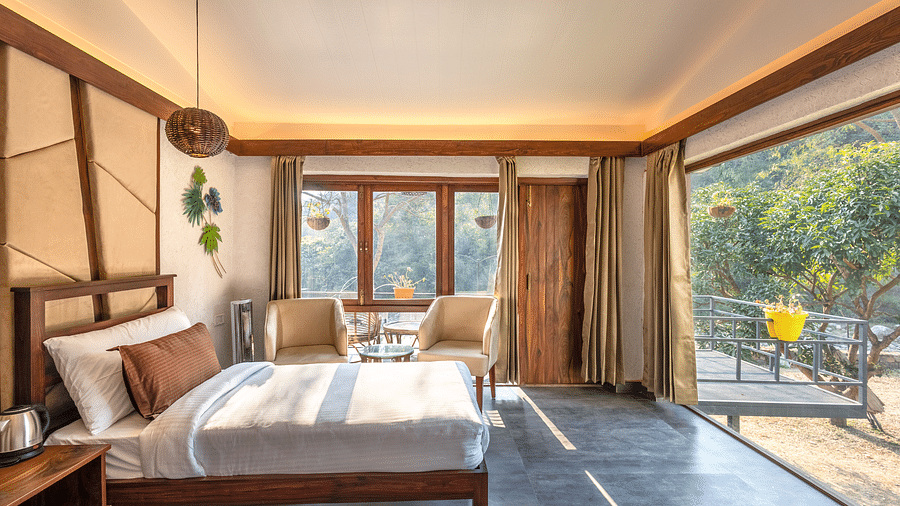 A small placed next to the chairs of River View Room at the Sylvan Retreat, Dehradun.