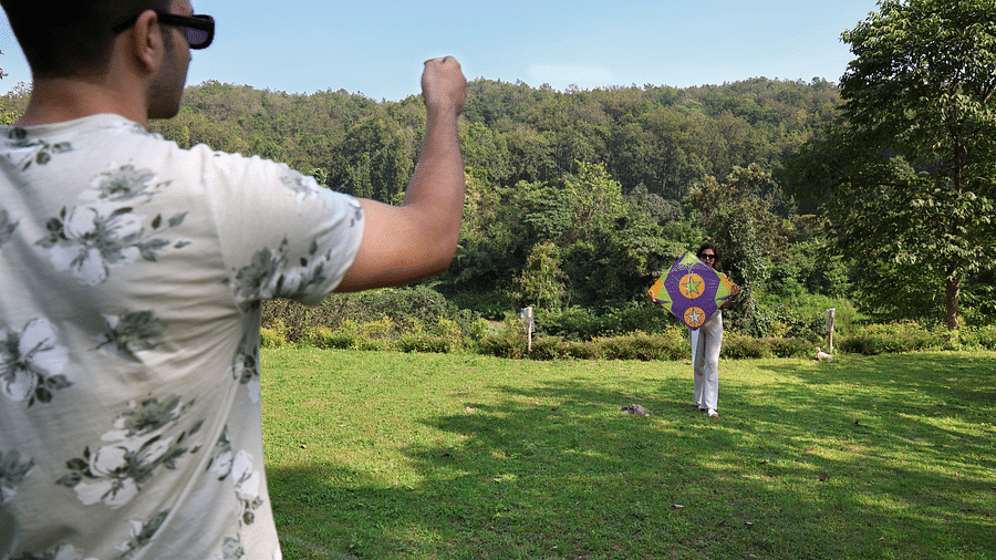 A man flying a kite at The Sylvan Retreat, Dehradun.