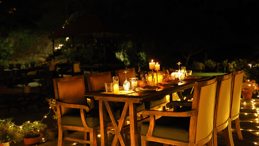 A lavish open-air dining setup at night at The Sylvan Retreat, Dehradun.