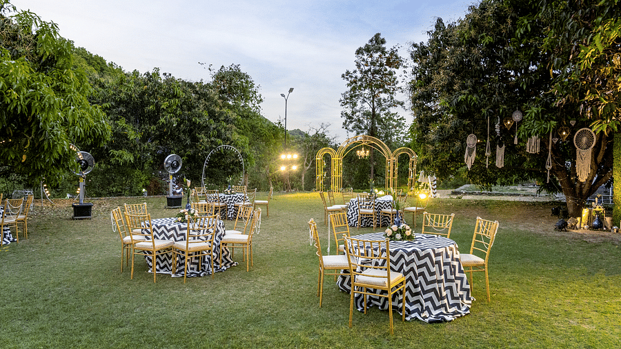 A view of a dining setup for a celebration in the lawn at The Sylvan Retreat, Dehradun.