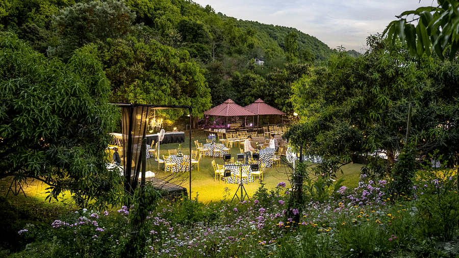 A view from a far angle of a wedding setup in the lawn at The Sylvan Retreat, Dehradun.