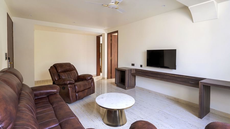 Overview of the living room with sofas and tv in view - The Tanisi Hotels & Resorts, Goa