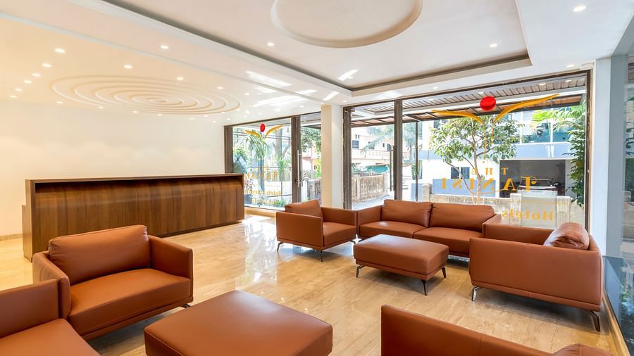 Overview of the lobby with sofas and reception desk in the background - The Tanisi Hotels & Resorts, Goa
