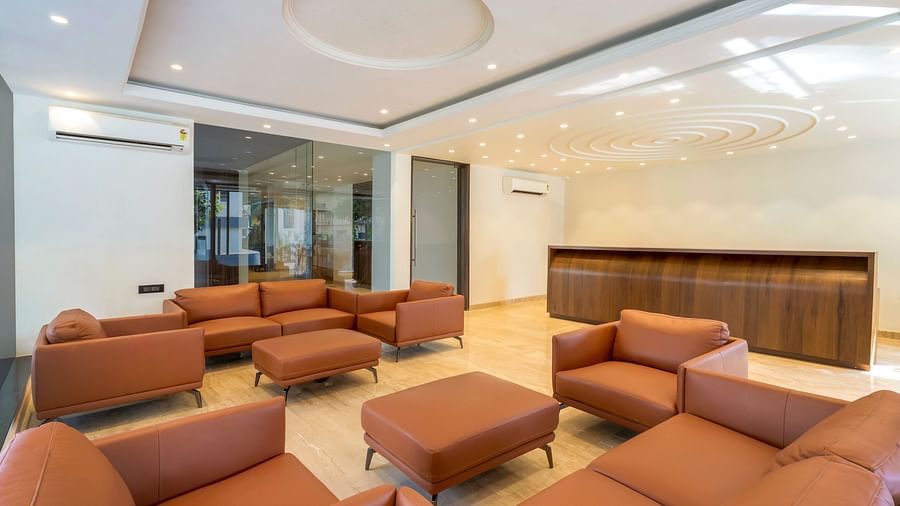 Overview of the lobby with sofas and reception desk in the background - The Tanisi Hotels & Resorts, Goa