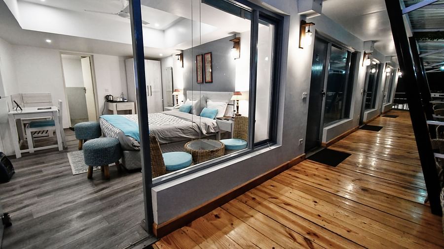 image of the balcony adjoining with the premium room with wooden flooring - The Tattva Boutique Resort