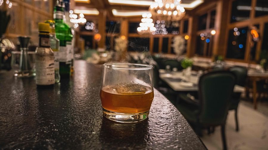 image of a drink served in a glass kept on a black platform at the alpenrose restaurant - the tattva boutique resort