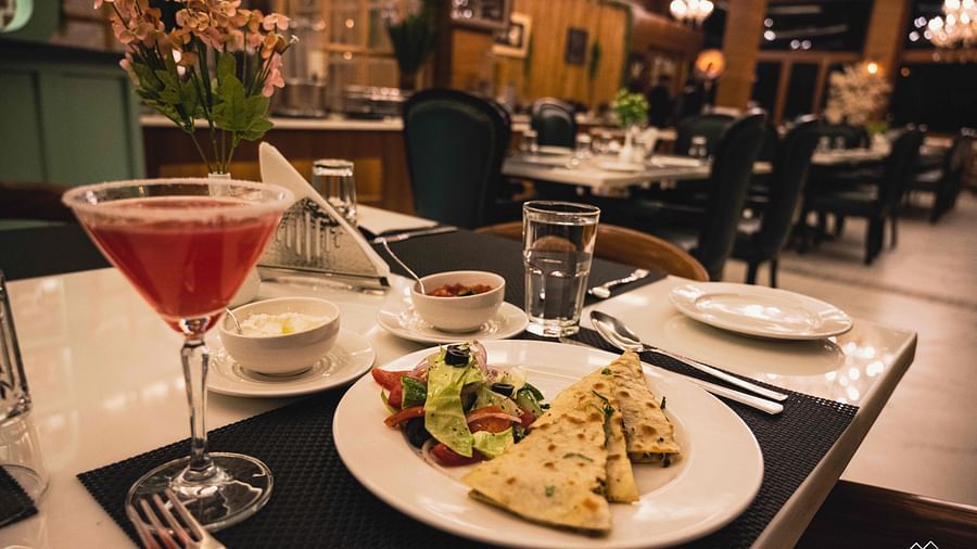image of food served on a white plate with salad served with a red coloured beverage - the tattva boutique resort
