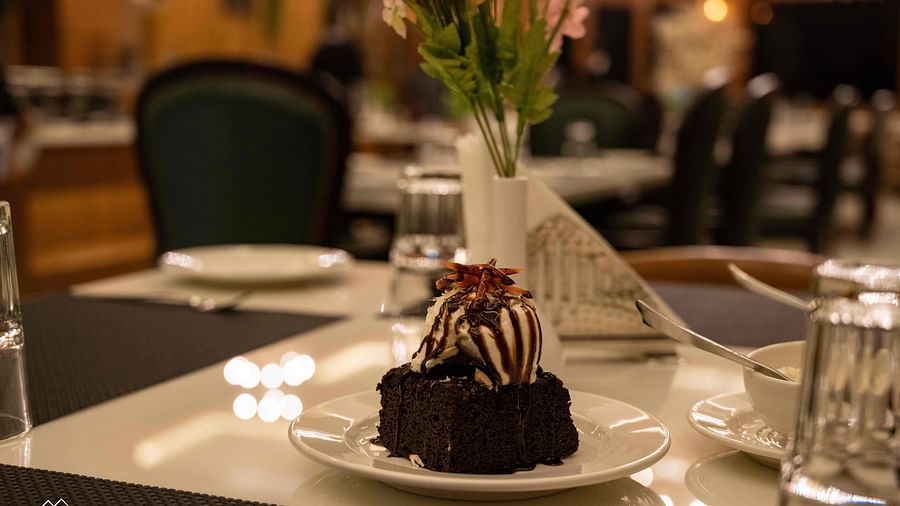 image of an ice cream scoop served with a brownie at the alpenrose restaurant- the tattva boutique resort