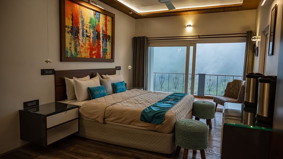 image of the bedroom at the pent house with a balcony in the far end of the room with beautiful views of the valley - The Tattva Boutique Resort
