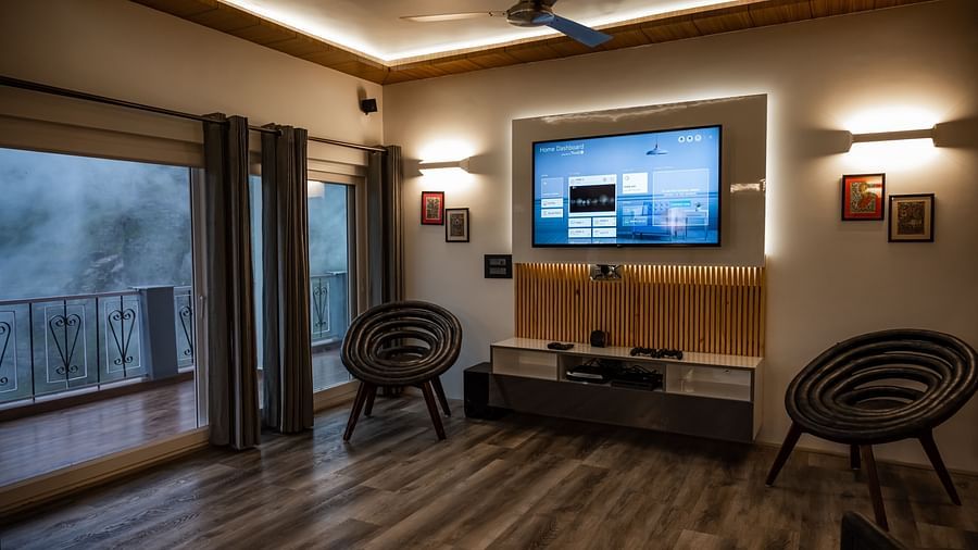 image of the living room of the pent house featuring a huge wall mounted television - The Tattva Boutique Resort