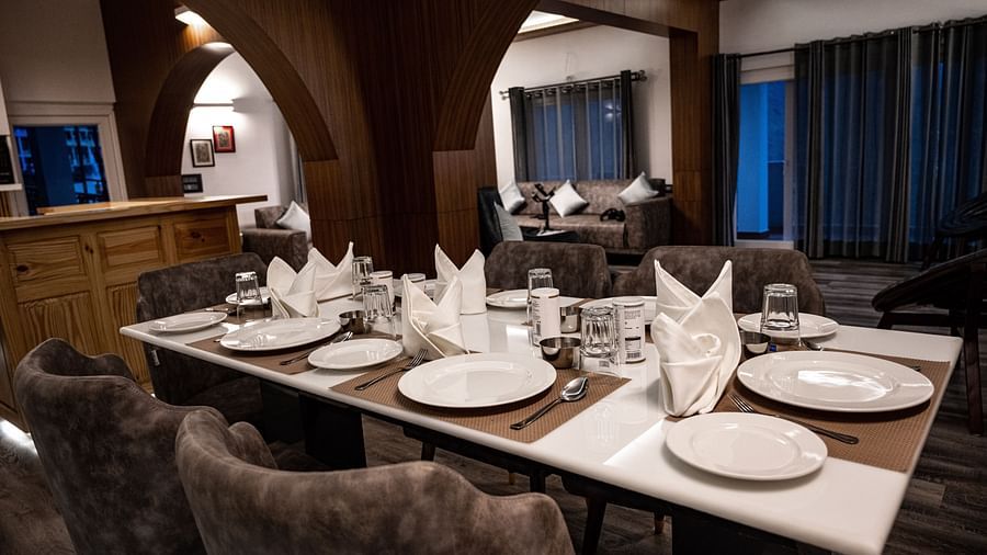 image of a wellset dining table in the pent house with cutlery and napkins - The Tattva Boutique Resort