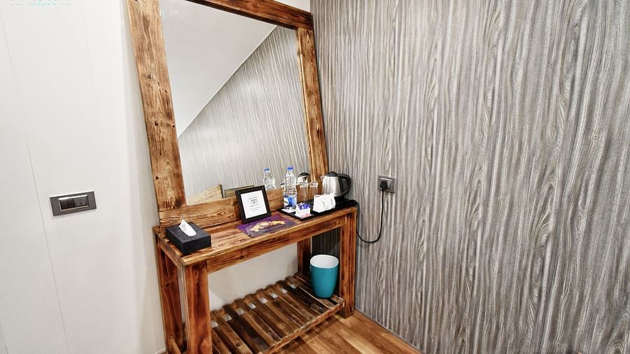 image of a dressing table with a square shaped mirror in the standard room - The Tattva Boutique Resort