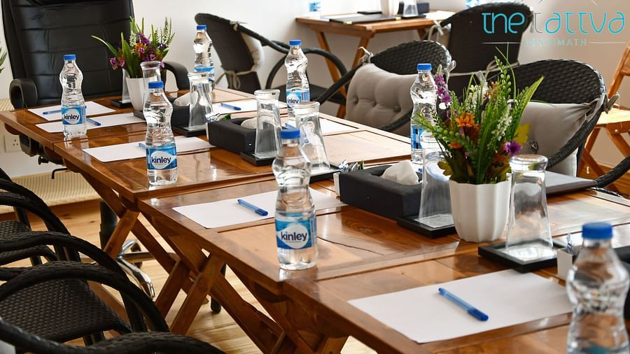 close up image of the table in the conference hall with white sheets kept on the table at the tattva, joshimath