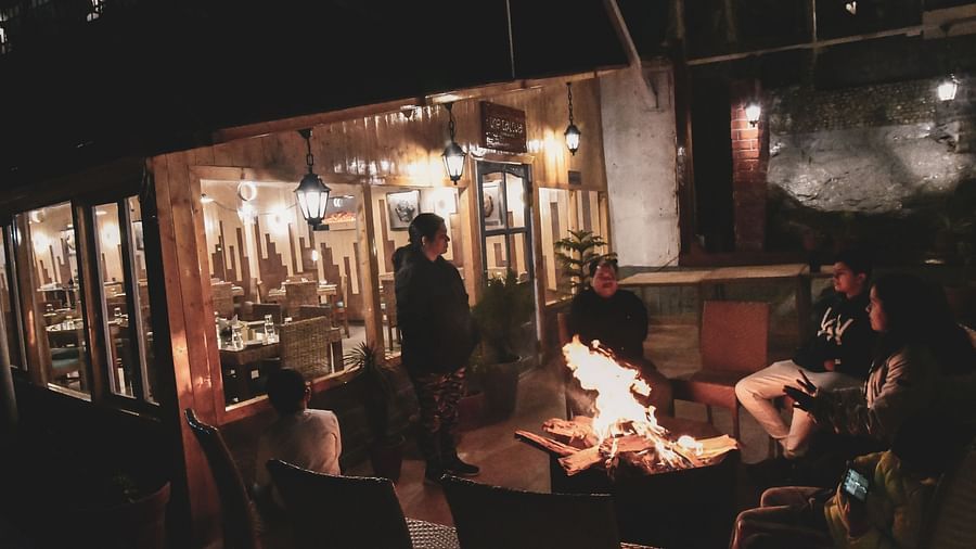 image featuring a family basking in the warmth of the bonfire at the tattva, joshimath