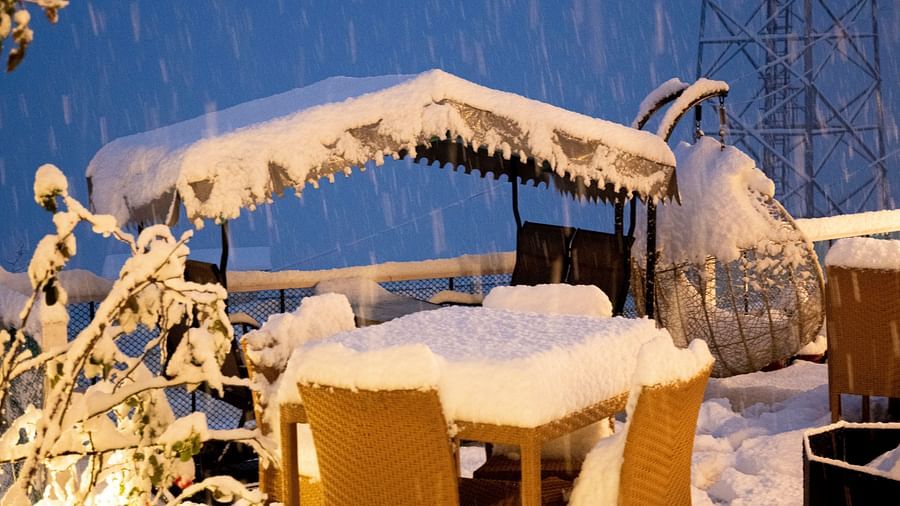 image of a swing with a shade over it with a thick layer of snow covering it