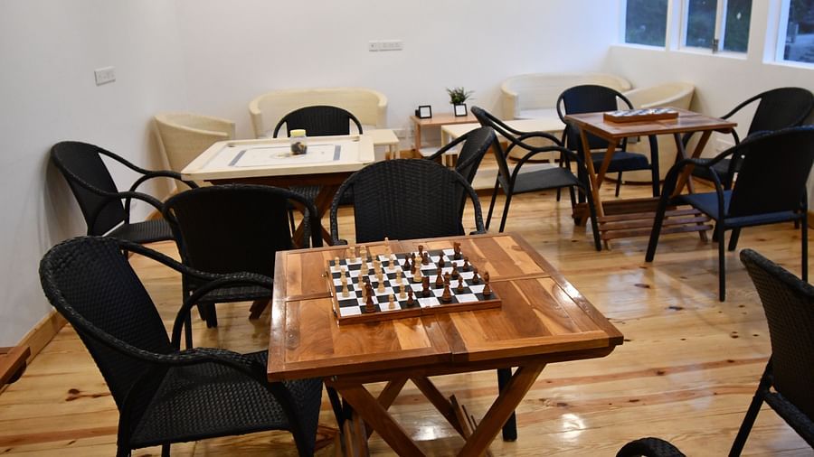 image of the indoor games area featuring a chess board kept on a wooden table at the tattva, joshimath