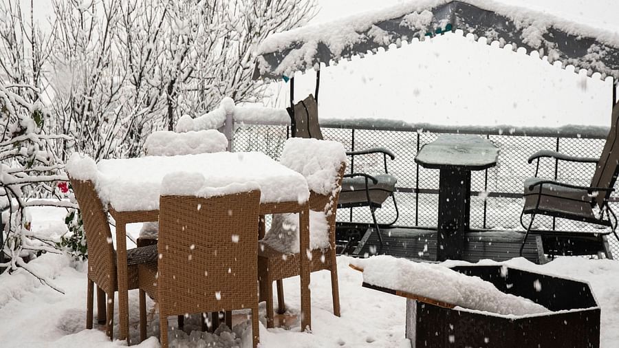 image of the outdoor seating area with a fire place in the foreground at the tattva, joshimath