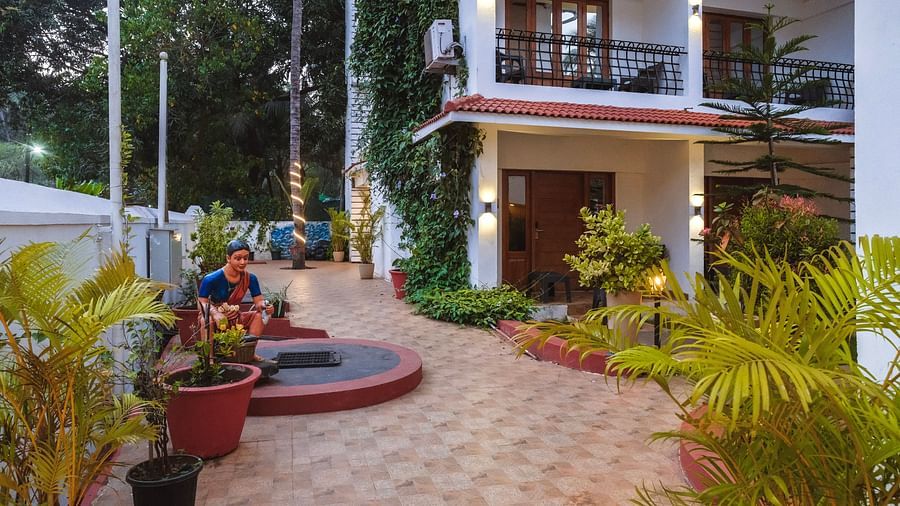 Spacious tiled courtyard with potted plants and a circular seating area at The Verda de Miranda Resort.