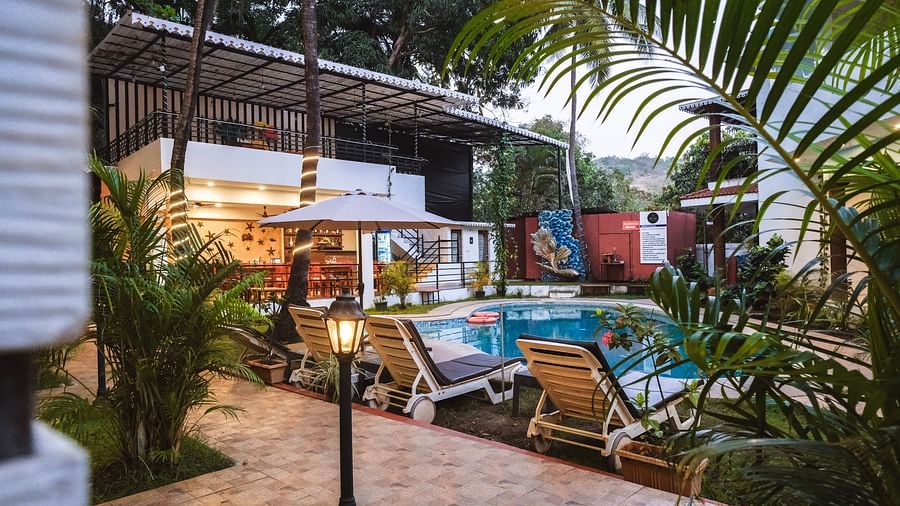 A vibrant poolside lounge with sunbeds, potted plants, and a relaxed open-air setting – The Verda de Miranda Resort.