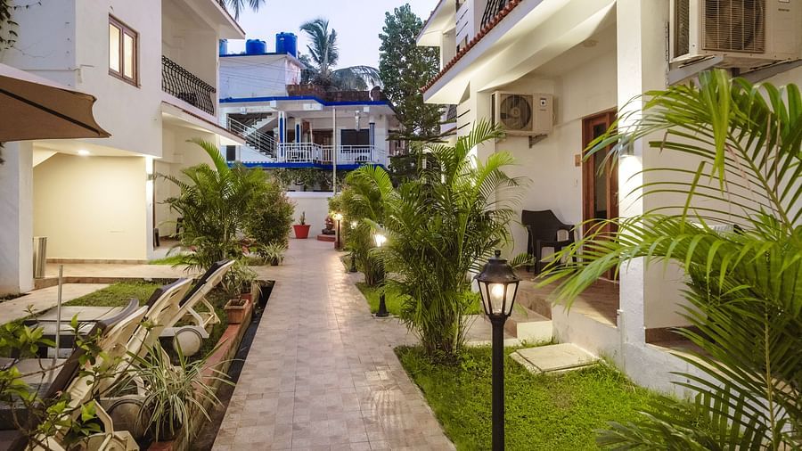 Paved garden pathway lined with plants and traditional lanterns at The Verda de Miranda Resort.