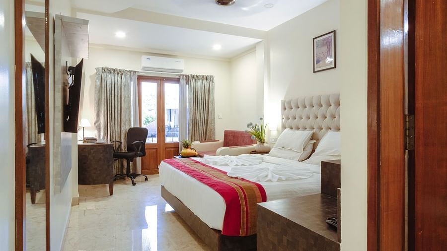 A bedroom with a bed, neutral tones, and ceiling fan, opening to natural light – The Verda de Miranda Resort.