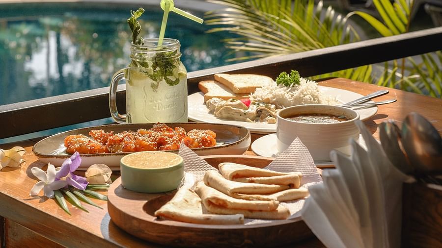 Close-up of assorted appetisers, dips, and drinks served poolside at The Verda de Miranda Resort.