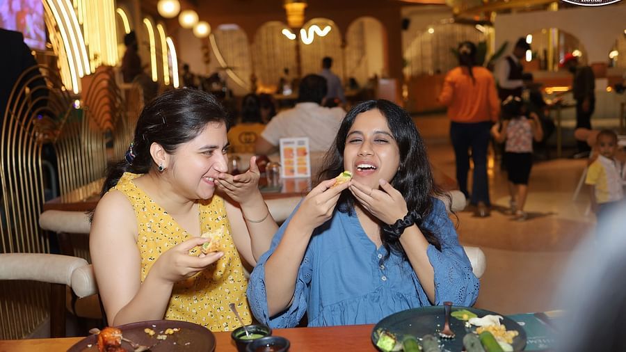 An image of two women eating at a barbecue house in Themis Barbecue House, Ambala