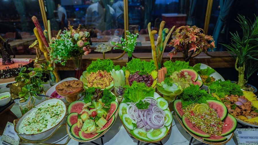 An image of a salad dressing along with various other dishes placed in a table at - Themis Barbecue House, NSP Pitampura