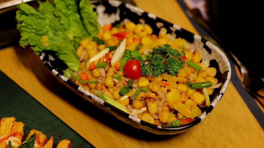 An image of fried corn severed and garnished with coriander leaves and lettuce at Themis Barbecue House, NSP Pitampura