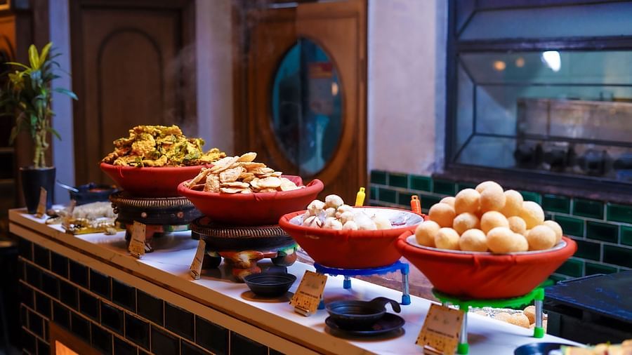An image of a food court featuring fritters and other fired food items at Themis Barbecue House, Panipat