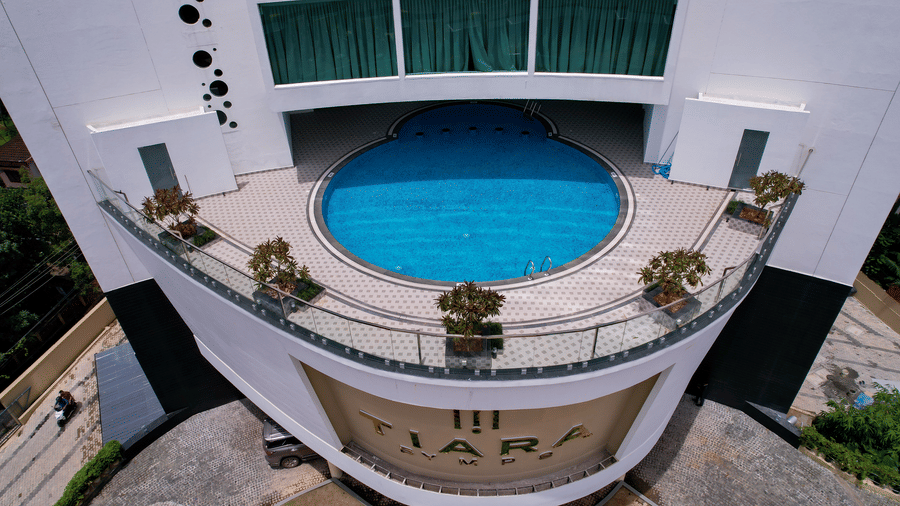 Aerial view of a circular swimming pool on an elevated terrace platform at Tiara by MPS.